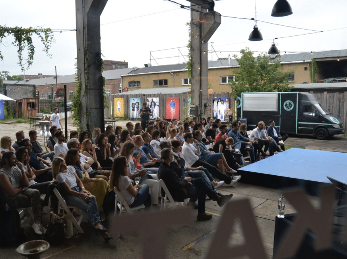 people sitting infront of an outside stage