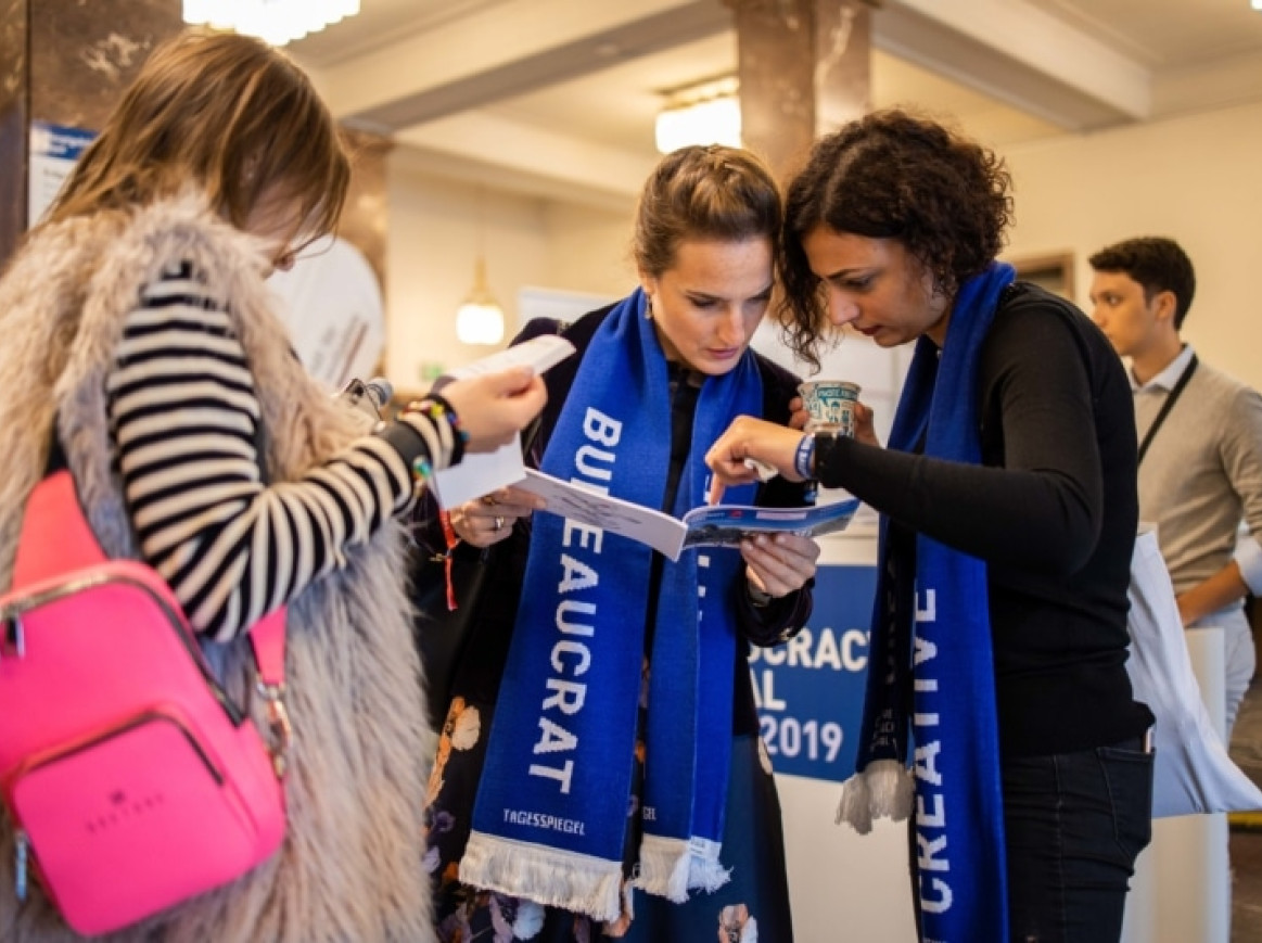 woman with creative bureaucracy scarfs talking to each other 